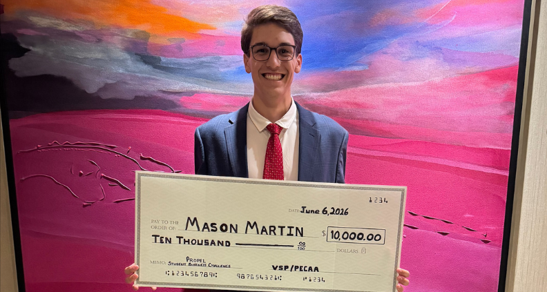 Mason Martin, winner of the 2026 Propel Student Business Challenge Scholarship, holding large $10,000 check